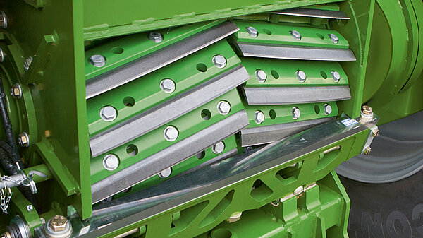 The material is pulled over the blades