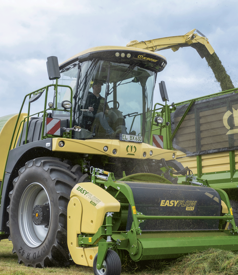 forage harvester being driven by farmer