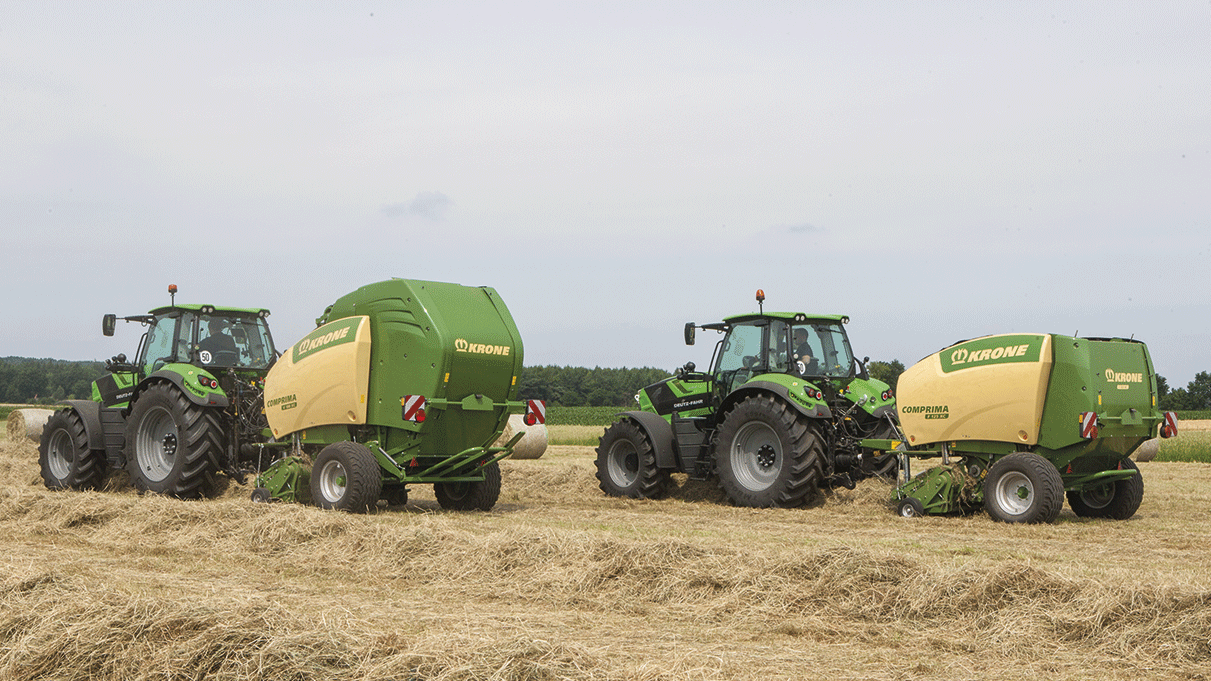 Two KRONE UK Comprima Round Balers in field